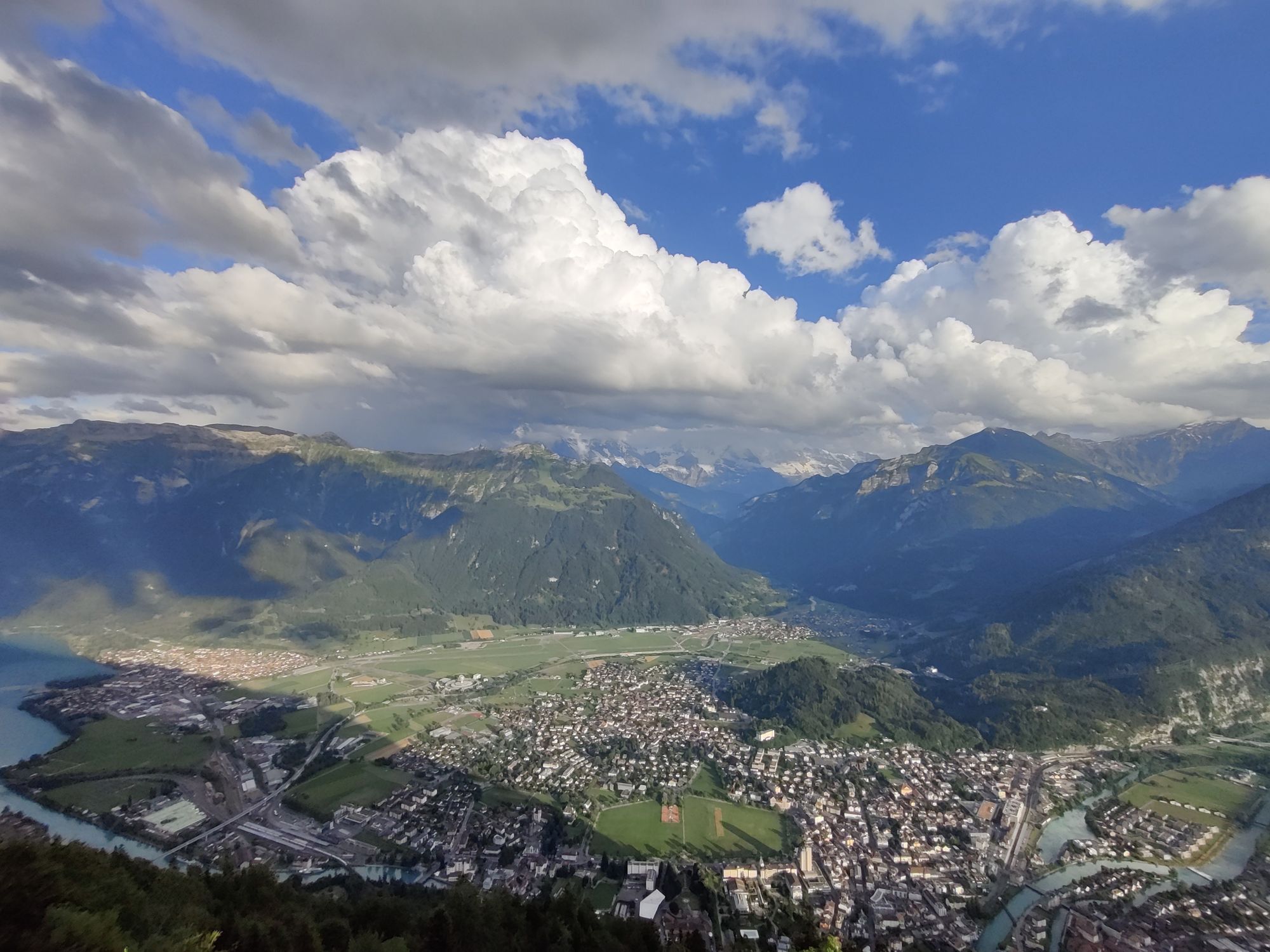 Photo from the Harder Kulm viewing point looking out over the town of Interlaken with a large mountainscape in the background.